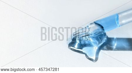 Pipette With Blue Gel, Transparent Fluid Hyaluronic Acid. Cosmetics, Science And Healthcare Concept 