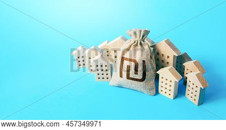 Israeli Shekel Money Bag Surrounded By Houses. Real Estate Investment. Mortgage Loan. Budget. Constr