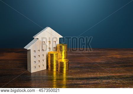 Houses And Golden Coins. Savings On Household Bills. Energy Efficiency And Energy Saving. Profit Fro