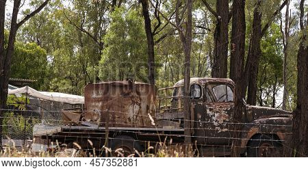 Old Rusting Truck With A Water Tank On The Back Sitting Rotting Away Amongst The Trees On The Fossic