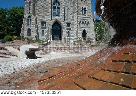 Omaha, Nebraska, Us - 5.2022 - Selective Focus On Fountain In Front Of St. Johns Parish Catholic Chu