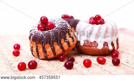 Brown And White Two Delicious Cakes With Cover Of Red Jelly Beans. Fresh Home Made And Tasty Cupcake