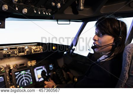 Young Copilot Using Power Switch On Dashboard To Fly Aircraft Jet, Pushing Control Panel Lever And N
