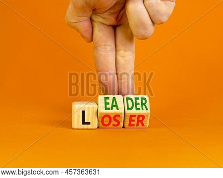 Loser Or Leader Symbol. Concept Words Loser Or Leader On Wooden Cubes. Businessman Hand. Beautiful O