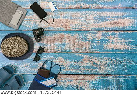 Man Vacation Accessories On The Blue Wooden Boards. Travel Hats, Camera, Glasses, Ticket Holder, Fli