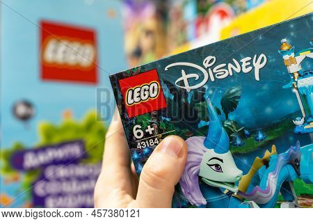 Close-up Of A Lego Constructor In A Customer's Hand. A Customer Takes A Box Of Lego From A Shelf In 
