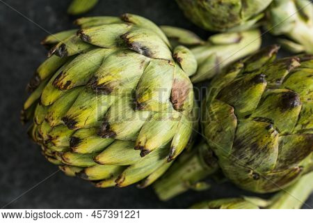 Fresh Artichoke On Black Background. Raw Artichok Closeup