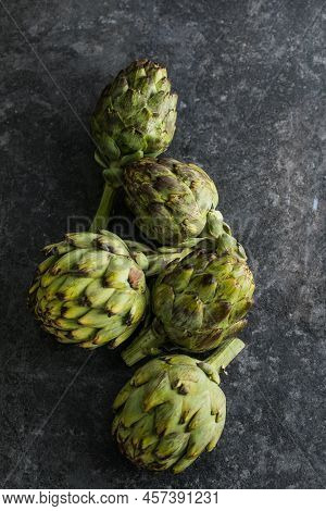 Fresh Artichoke On Black Background. Raw Artichok Closeup