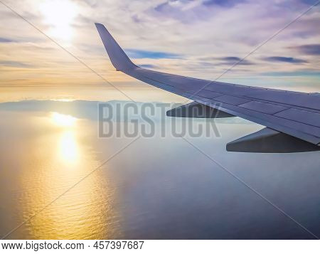 View From The Plane Window On The Island Of Tenerife In The Atlantic Ocean At Dawn. The Wing Of An A