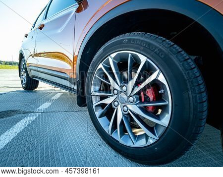 Minsk, Belarus - June 2022: Close-up Of A Geely Coolray Car Orange Wheel.
