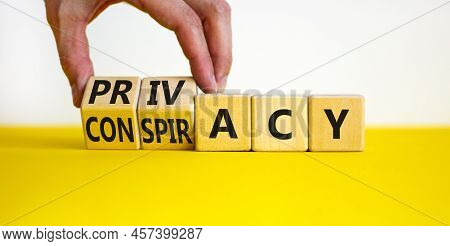 Privacy Or Conspiracy Symbol. Businessman Turns Wooden Cubes And Changes The Word Conspiracy To Priv