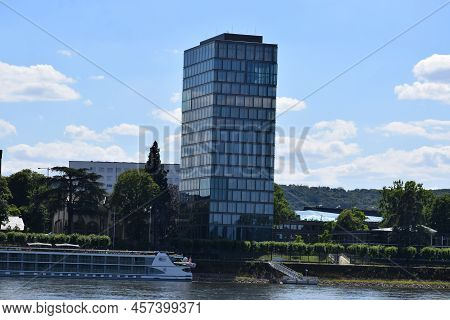 Bonn, Germany - 06 28 2022: Skyscraper At The Rhine With A Ship