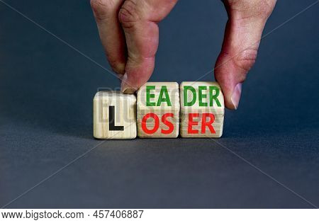 Loser Or Leader Symbol. Concept Words Loser Or Leader On Wooden Cubes. Businessman Hand. Beautiful G