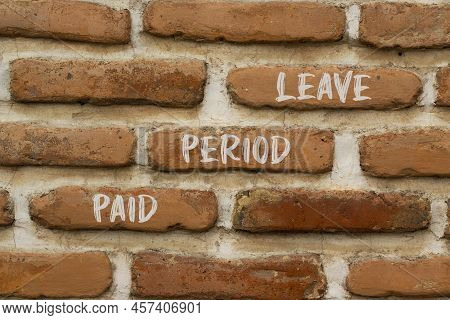 Paid Period Leave Symbol. Concept Words Paid Period Leave On Brick Wall. Beautiful Brick Wall Backgr