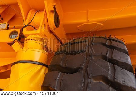 Huge Rear Wheels Of Dump Truck At Unusual Angle Closeup.