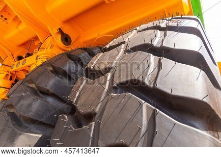 Huge Rear Wheels Of Dump Truck At Unusual Angle Closeup.