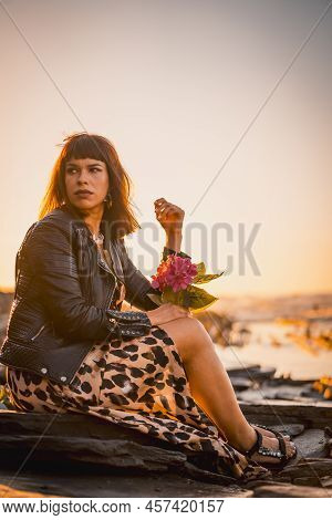 Summer Street Style On A Beach Next To Rocks Of A Young Brunette Caucasian Woman In A Leopard Dress 