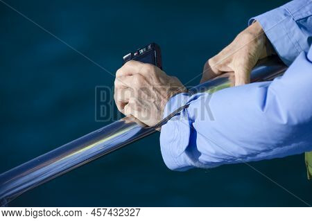 Hands Of A Person Leaning On The Railing Of A Southern Whale Watching Boat On The Coastline Of The F
