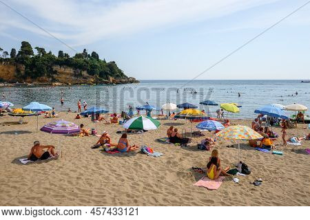 Ulcinj, Montenegro - June 4, 2022: Tourists On The Town Beach In Ulcinj. Ulcinj Is The Southernmost 