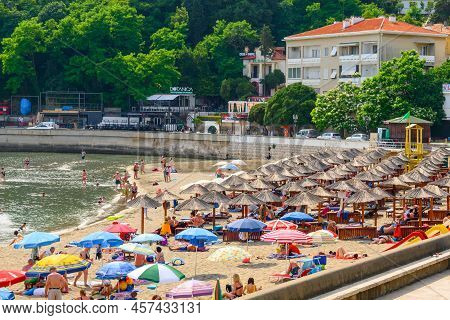 Ulcinj, Montenegro - June 4, 2022: Tourists On The Town Beach In Ulcinj. Ulcinj Is The Southernmost 