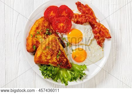 Irish Breakfast Of Potato Farls, Fried Eggs,  Bacon Slices, Grilled Tomatoes And Fresh Lettuce On Wh