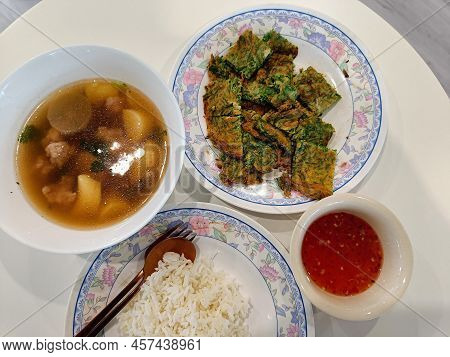 Top View. Thai Food Menu. Kai Jeow Cha Om, Thai Omelette And Clear Soup With Boiled Soup Tofu And Mi