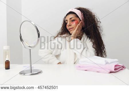 Lovely Happy Tanned Pretty Curly Latin Lady With Pink Patch For Eye Admiring Herself Reclines On Han