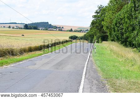 Bumpy Cracked Country Road With Potholes Everywhere