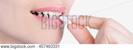 Close-up Of Womans Face And Female Hand Putting Into Mouth Chewing Gum. Lady Enjoying Sweet Gum For 