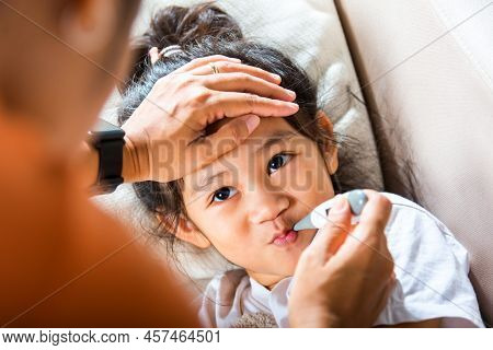 Sick Kid. Mother Parent Checking Temperature Of Her Sick Daughter With Digital Thermometer In Mouth,