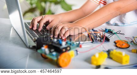 Asian Kid Boy Learns Coding And Programming With Laptop For Arduino Robot Car, Little Child Students