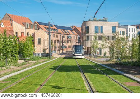 Odense, Denmark - May 23 2022:  Tracks Of The Tram Or Trolley Bus On A Road With Green Grass. Electr