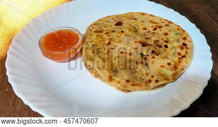 Aloo Parantha An Ideal Indian Breakfast Served With Tomato Sauce. Selective Focus