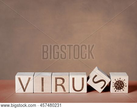 VIRUS text written on wooden blocks as a concept of the viral epidemic