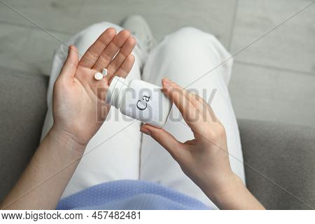 Calcium Supplement. Woman Taking Pills Indoors, Top View