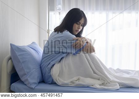 A Despondent Asian Woman Patient. Following The Doctor's Declaration That The Cancer Was Nearing The