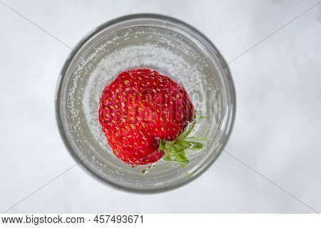 Strawberry Cocktail From Top View, Isolated On White Background. A Large Whole Strawberry In A Glass