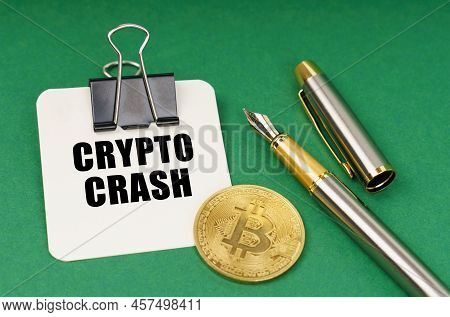 Cryptocurrency And Business Concept. On A Green Surface, A Bitcoin Coin, A Pen And A Sheet Of Paper 