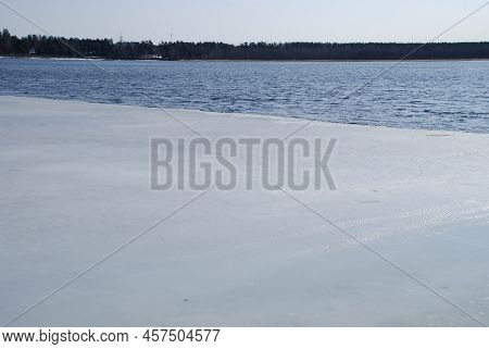 The River Bank Ice And Water Are Two Phases Of Matter Next To Each Other. Spring Day. Part Of The Wa
