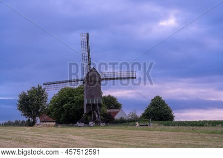 This Beautiful Mountain Mill Is Located In Wannegem-lede Belgium, With The Rise Of The Sun And  Clou