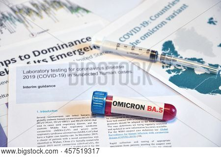 Blood Tube For Test Detection Of Virus Covid-19 Omicron Ba.5 Variant On Papers Document With Syringe