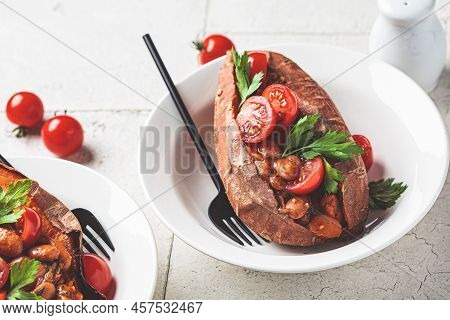 Baked Whole Sweet Potato Stuffed With Beans And Tomato. Vegan Recipe Concept.