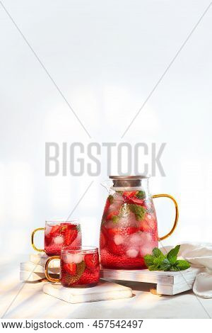 Strawberry Lemonade In Jug And Two Glass Glasses. Summer Drinks Season. Strawberries With Mint And I