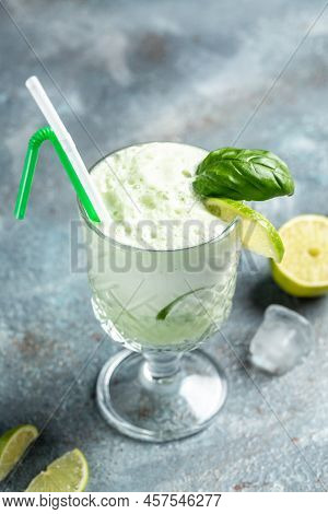 Basil Gin Alcoholic Cocktail. Long Alcohol Drink With Fresh Basil Leaves And Limes, In Highball Glas