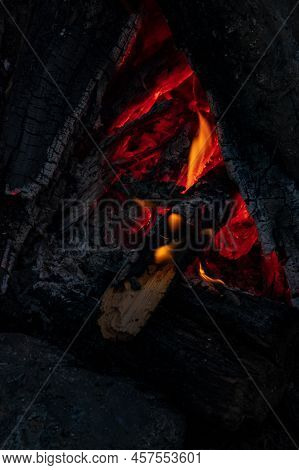Bright Flame Of A Burning Fire On A Dark Background. Slow Motion. Sparks And Flames. Burning Bonfire