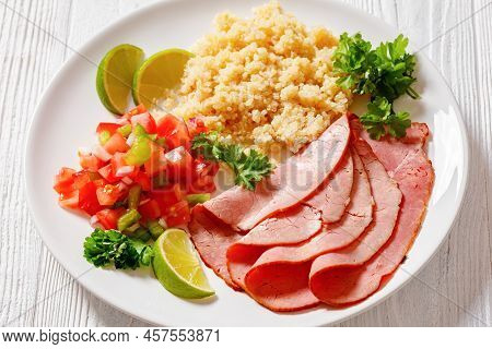 Delicious Thinly Sliced Roast Beef Fillet With Quinoa And Tomato Pepper Salsa On White Plate On Whit