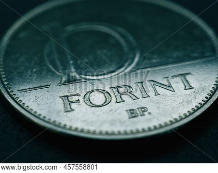 Hungarian Coin Of 10 Forints Lies On A Dark Surface Closeup. Money Of Hungary. News About Economy Or