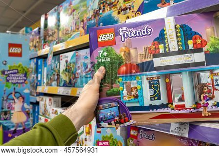 Lego Constructor In A Customer's Hand. A Customer Takes A Box Of Lego From A Shelf In A Store. Minsk