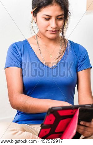 Bolivian Young Hispanic Woman Doing School Homework With Digital Tablet Technology