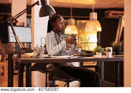 Office Employee Talking To Colleagues On Online Videocall Meeting, Using Remote Teleconference App T